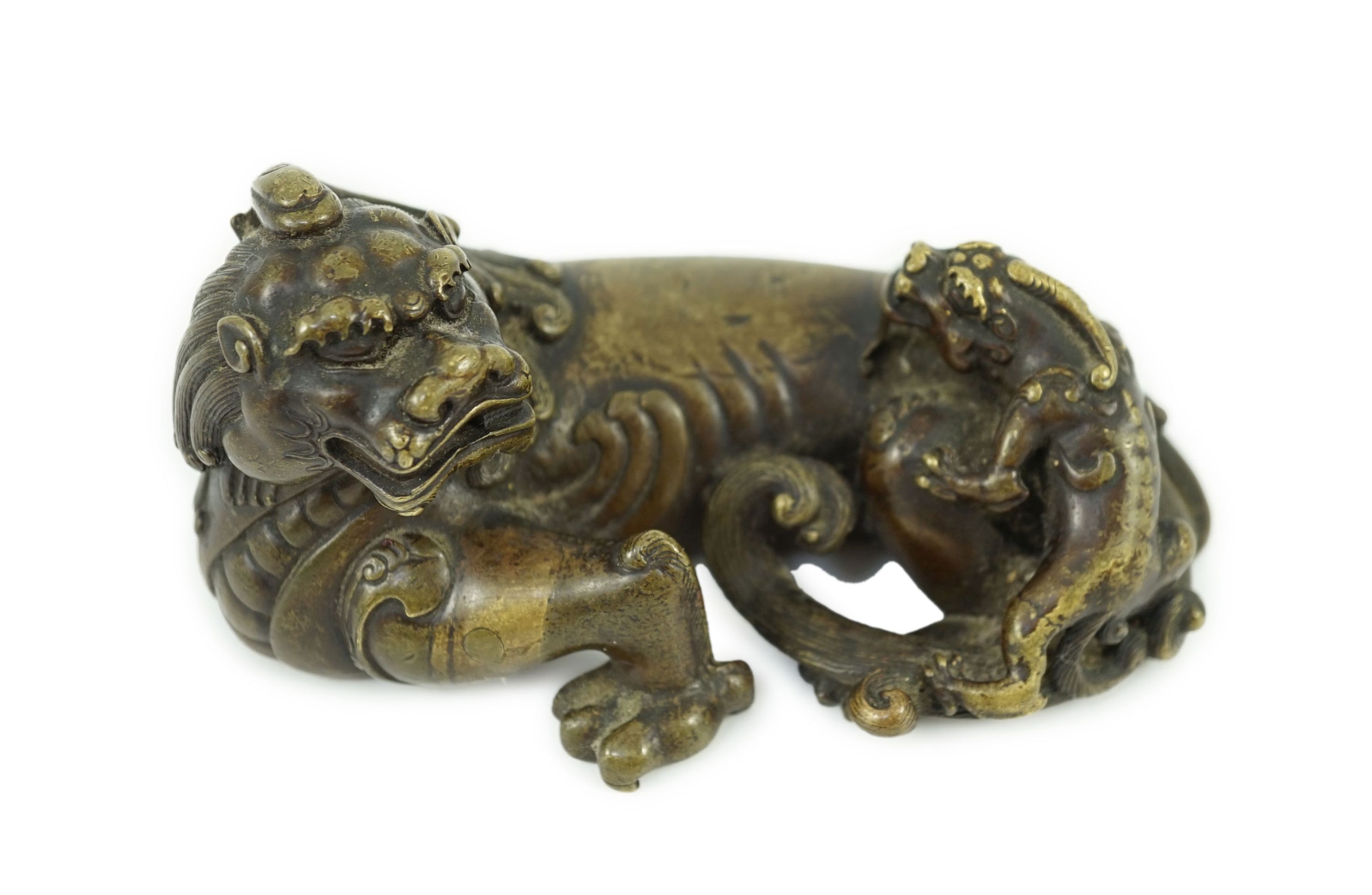 A finely cast Chinese bronze lion-dog and cub scroll weight, 17th/18th century, 14cm long, one foot and a cub lacking